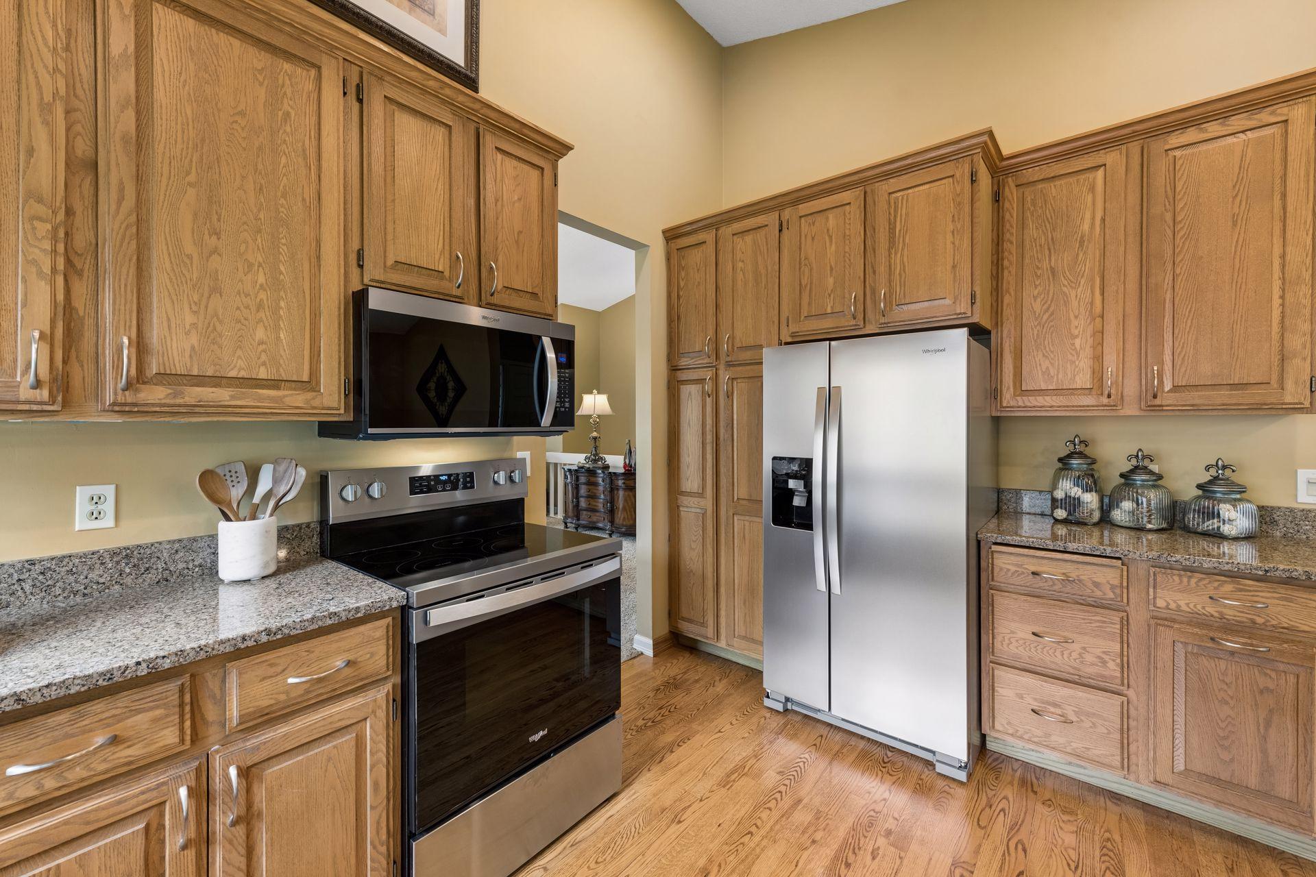 The kitchen is spacious, with a pantry, prep areas, and easy access to appliances, for a functional design.