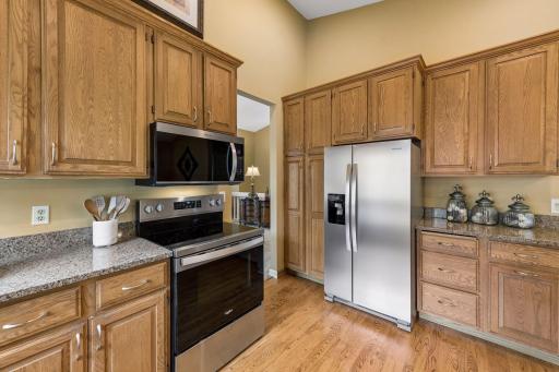 The kitchen is spacious, with a pantry, prep areas, and easy access to appliances, for a functional design.