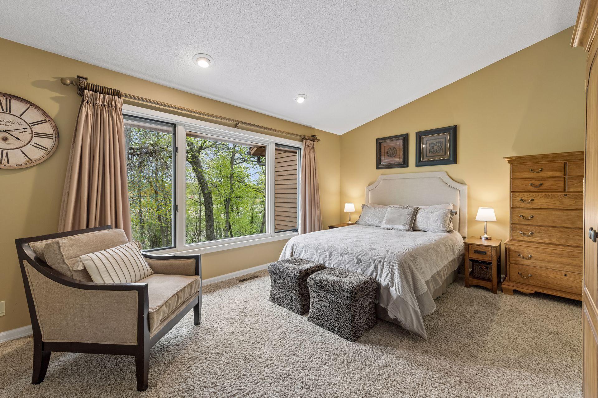 Spacious primary suite designed for comfort and privacy, and amazing wooded views. Dual closets and vaulted ceilings.