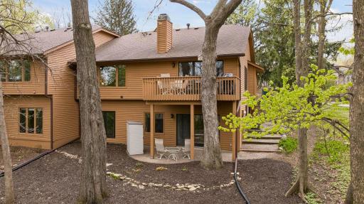 The lower-level patio space is tucked under the deck and provides for additional outdoor seating. The tiered steps along the side of the home make it easy to access the backyard from the front.