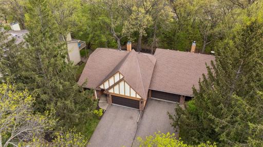 This aerial view shows that the home is surrounded by mature trees.