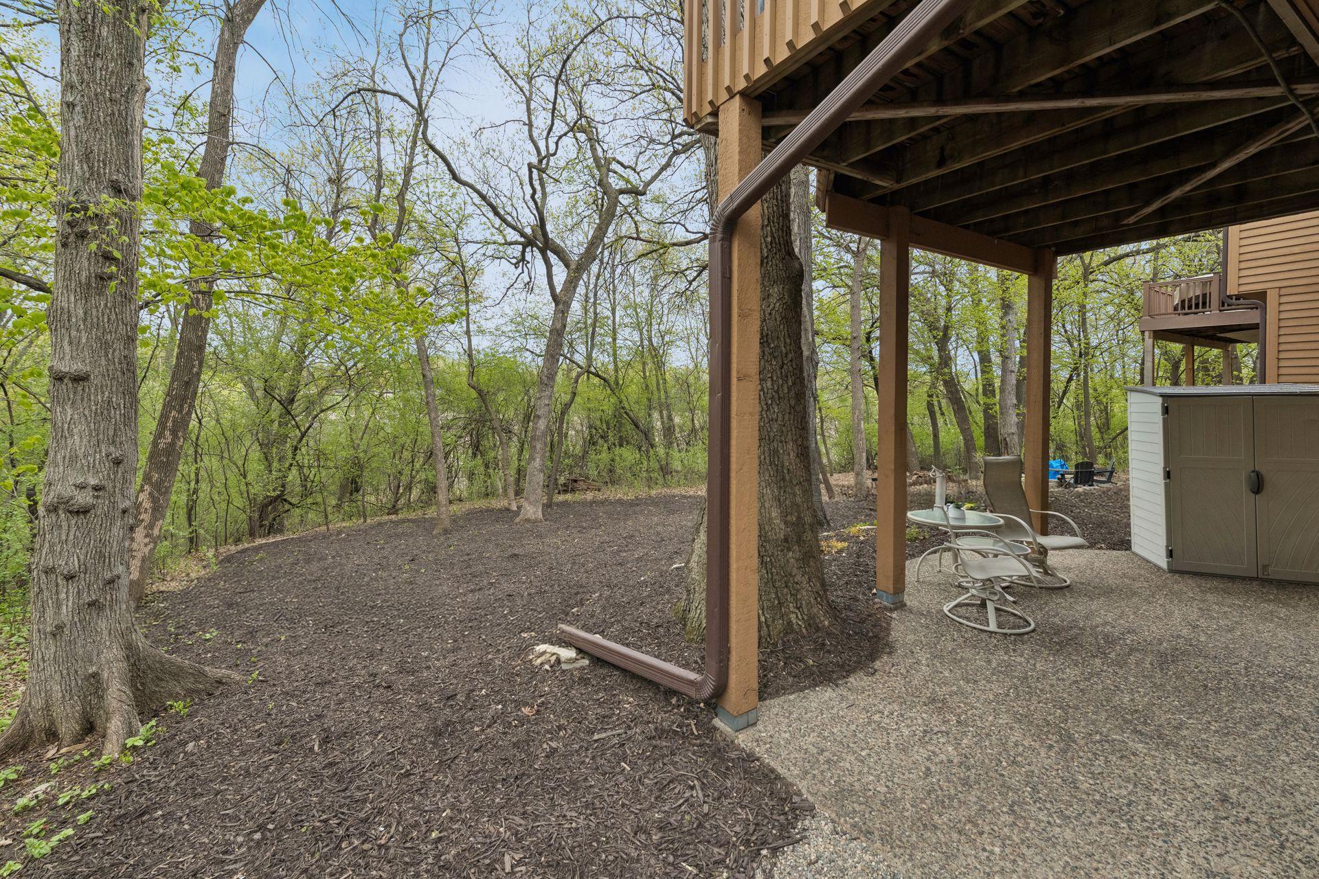 The walkout lower level opens to a wooded backyard setting with access to nearby nature trails.