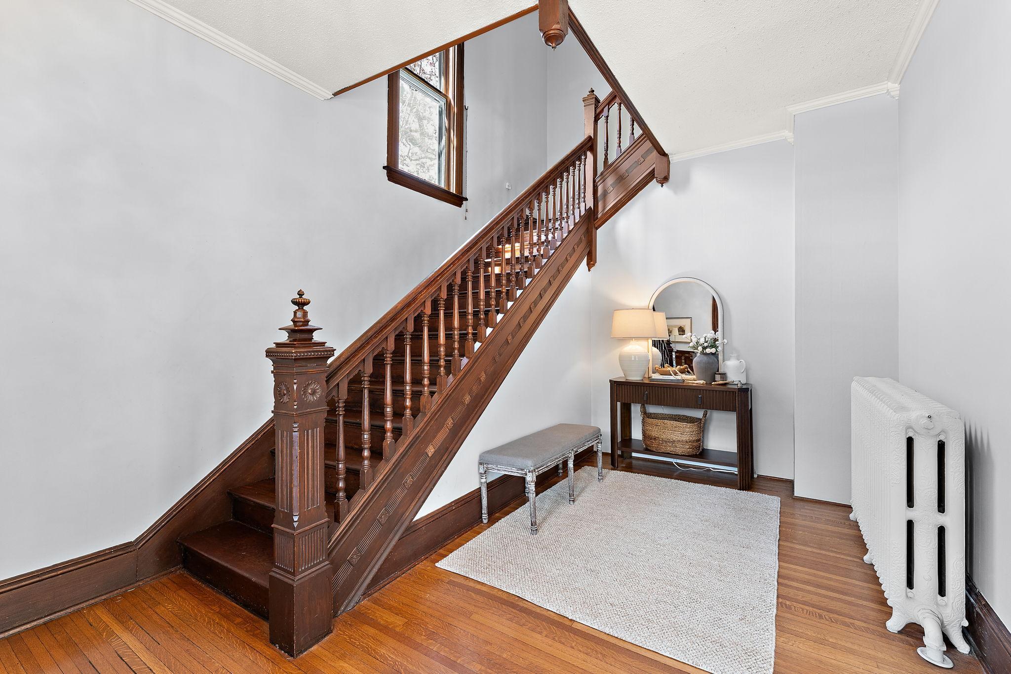 Timeless and gorgeous preserved details, warmth and texture throughout, and a lovely grand staircase in the spacious foyer