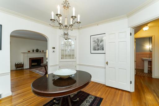 Dining room w/charming arched doorway and built in cabinet