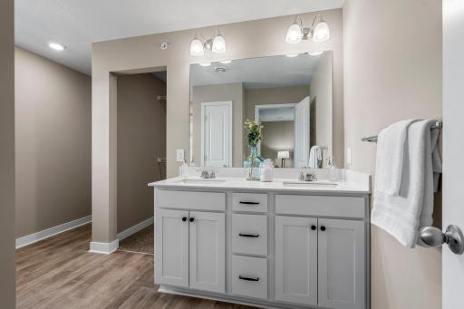 The suite features a Â¾ bathroom with dual sinks, a walk-in shower, and a spacious walk-in closet.