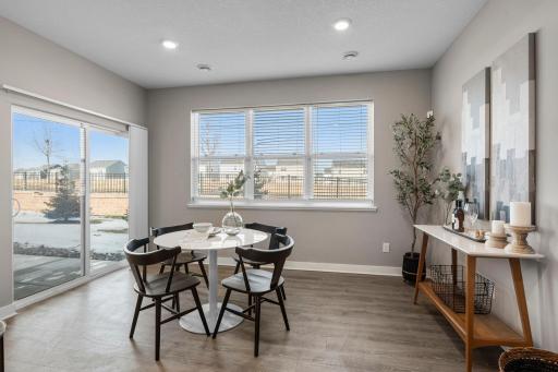 Just off the kitchen, the informal dining area showcases large windows with backyard views and access to the covered patio.