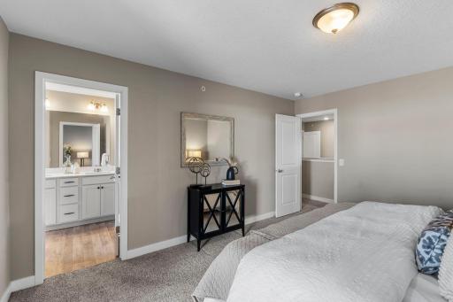 Another perspective of the primary bedroom, highlighting the entrance to the private 3/4 bathroom.