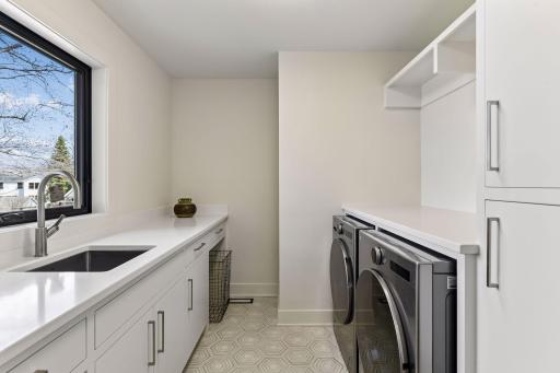 Upper level laundry with built-ins and folding counter.