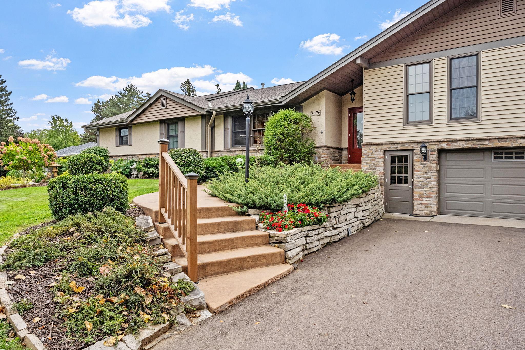 Lovely landscaping with abundance of limestone, perennials, shrubs and gardens
