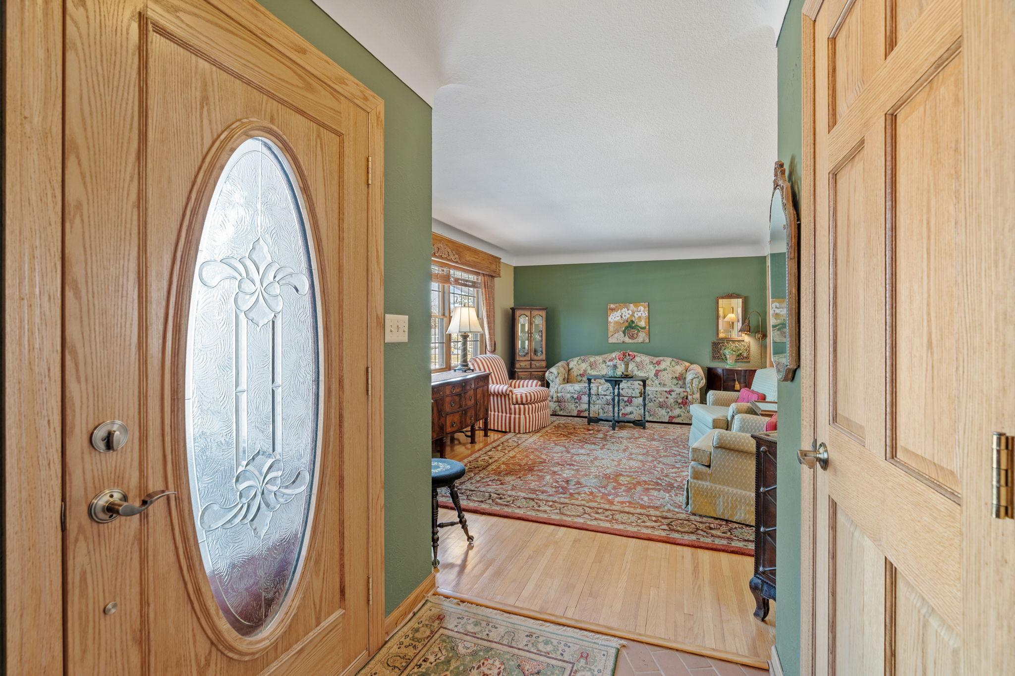 Elegant living room off entryway with quality hardwood oak floors