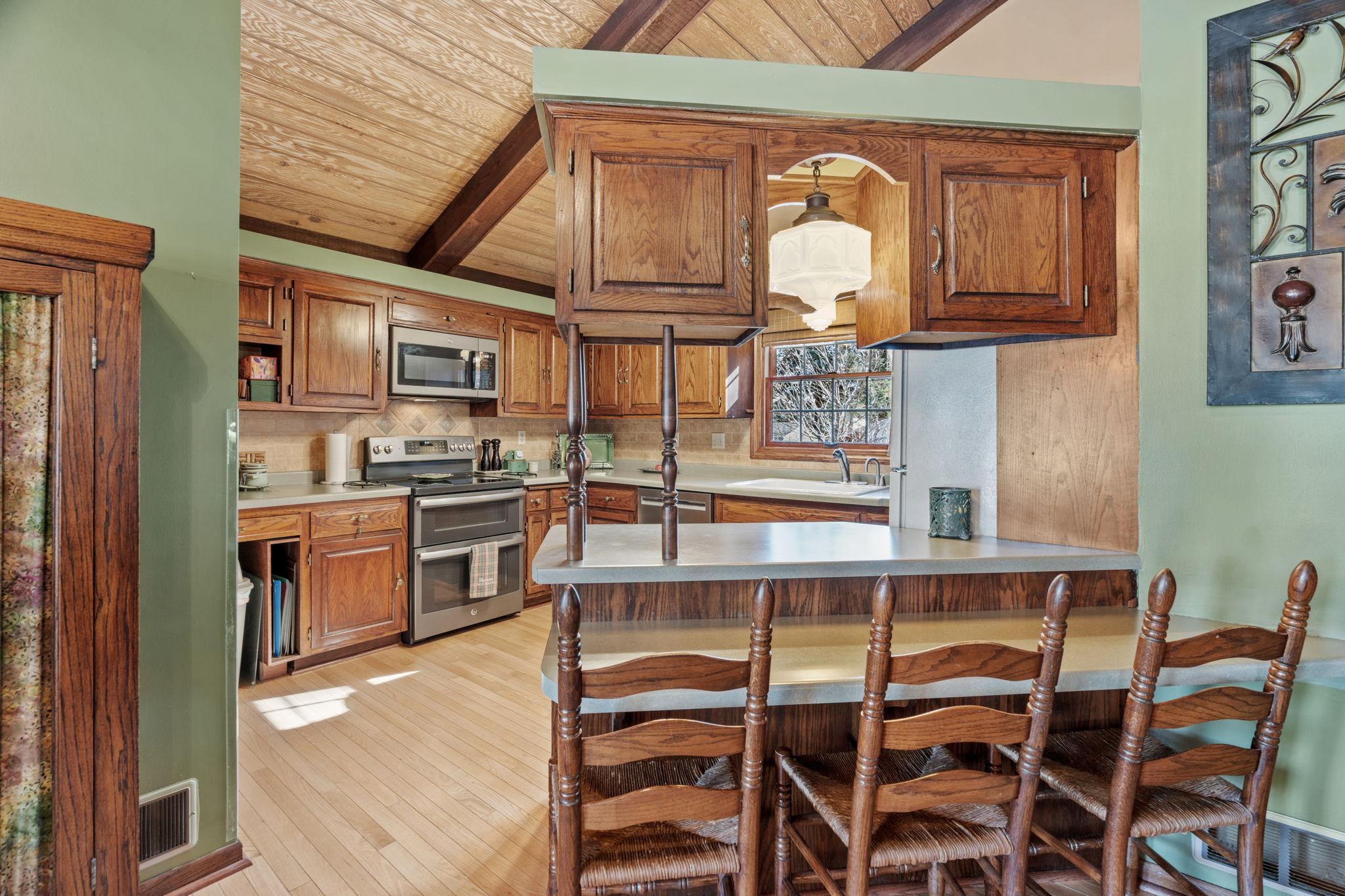 You'll enjoy the kitchen with solid oak floors, stainless appliances and ideal breakfast/lunch counter