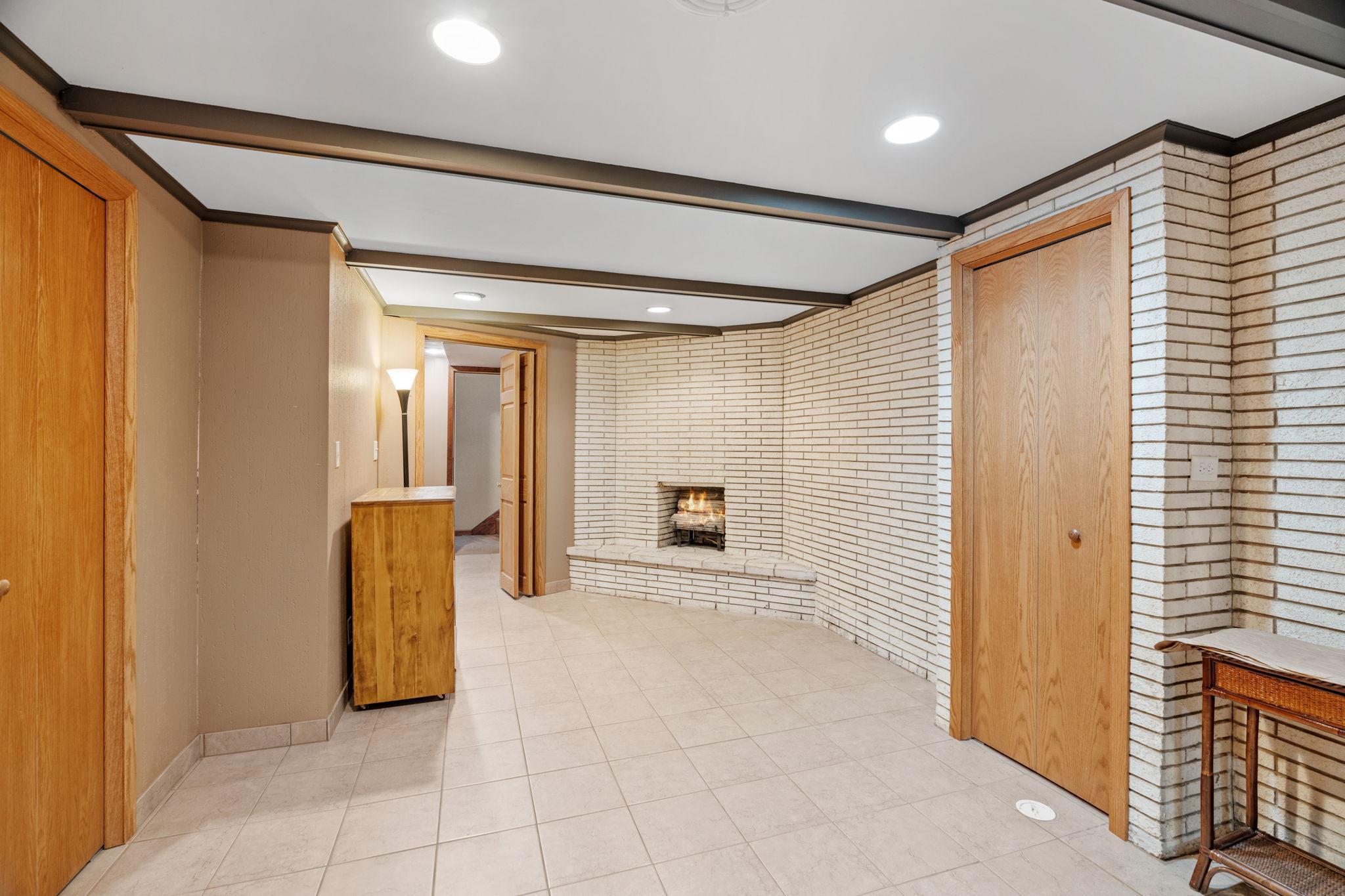 Lower level amusement with tiled floors and full wall brick fireplace..."This fireplace is not currently functional"