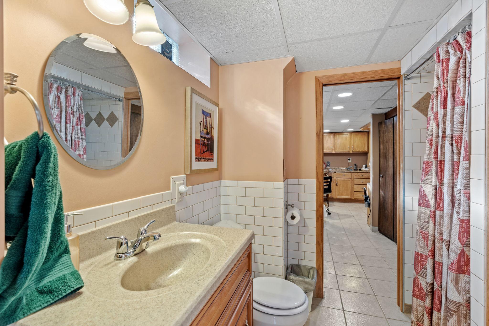 Convenient lower level 3/4 bath with attractive subway tile