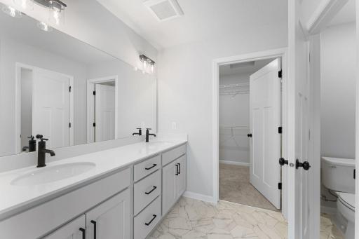 Owners bath with double vanity and walk in shower