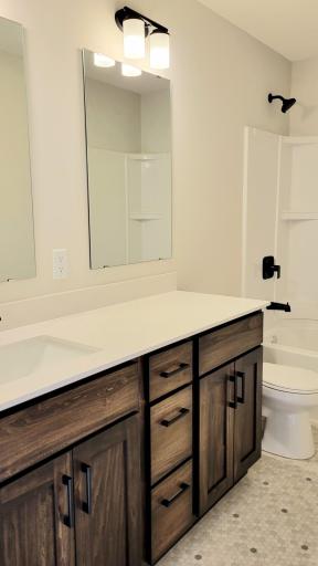 Well-appointed upper-level hall bathroom, designed for spacious convenience and comfort for all.