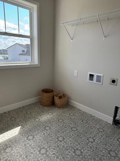 Charming and convenient upper-level laundry room offers lots of space for your everyday needs.