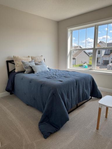 On the upper level, the three secondary bedrooms all offer exceptional natural lighting and comfortable versatility, making them perfect for guests and kids or used as a media den and private workspace.