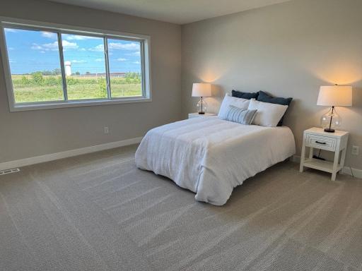 Relaxing owner's retreat with generous proportions for a reading nook or workspace, beautiful open-sky views, and abundant natural lighting.