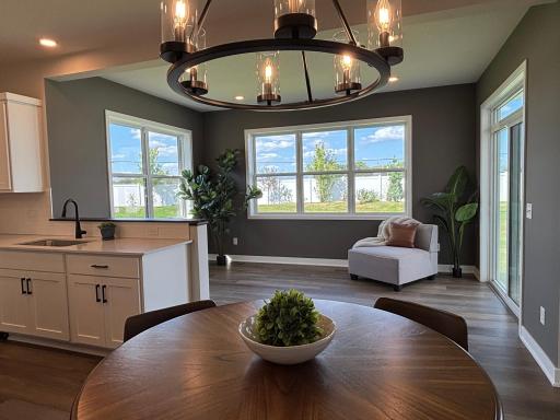 Stunning window-lined morning room filled with warm lighting for relaxing mornings and peaceful backyard views. The large dedicated sun-filled dining space can accommodate even the largest farmhouse table for holiday gatherings or everyday meals.
