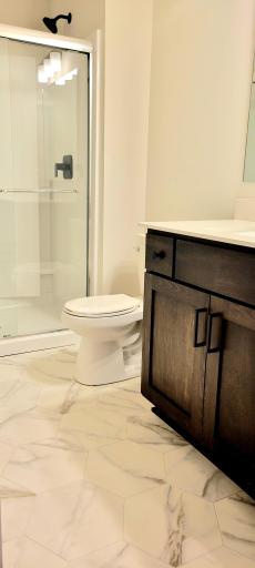 Full lower-level bath adds convenience for visiting guests and entertaining needs.