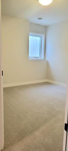 Private lower-level bedroom ideal for guests or multigenerational living.