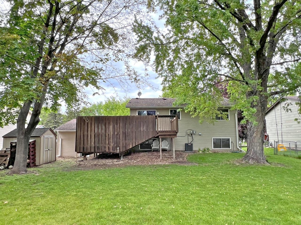 Rear view with enclosed deck & mature shade trees