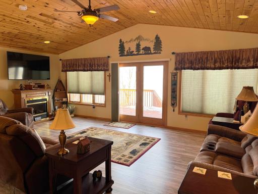Another angle of the living room featuring the wall of windows overlooking the lake...