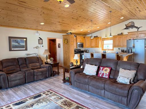 A shot of the living room/great room layout with the kitchen beyond.