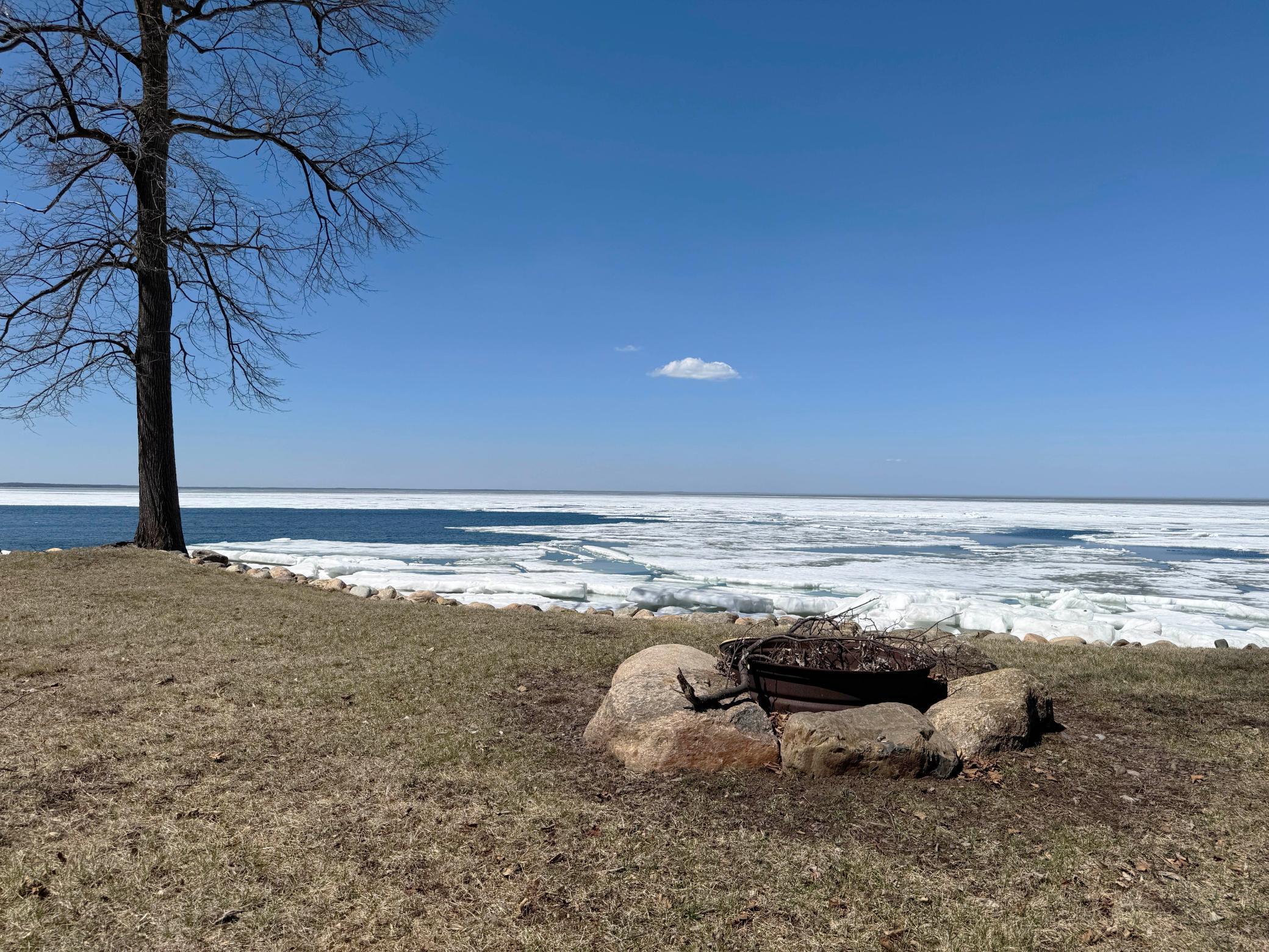 Another angle of the firepit with the lake beyond.