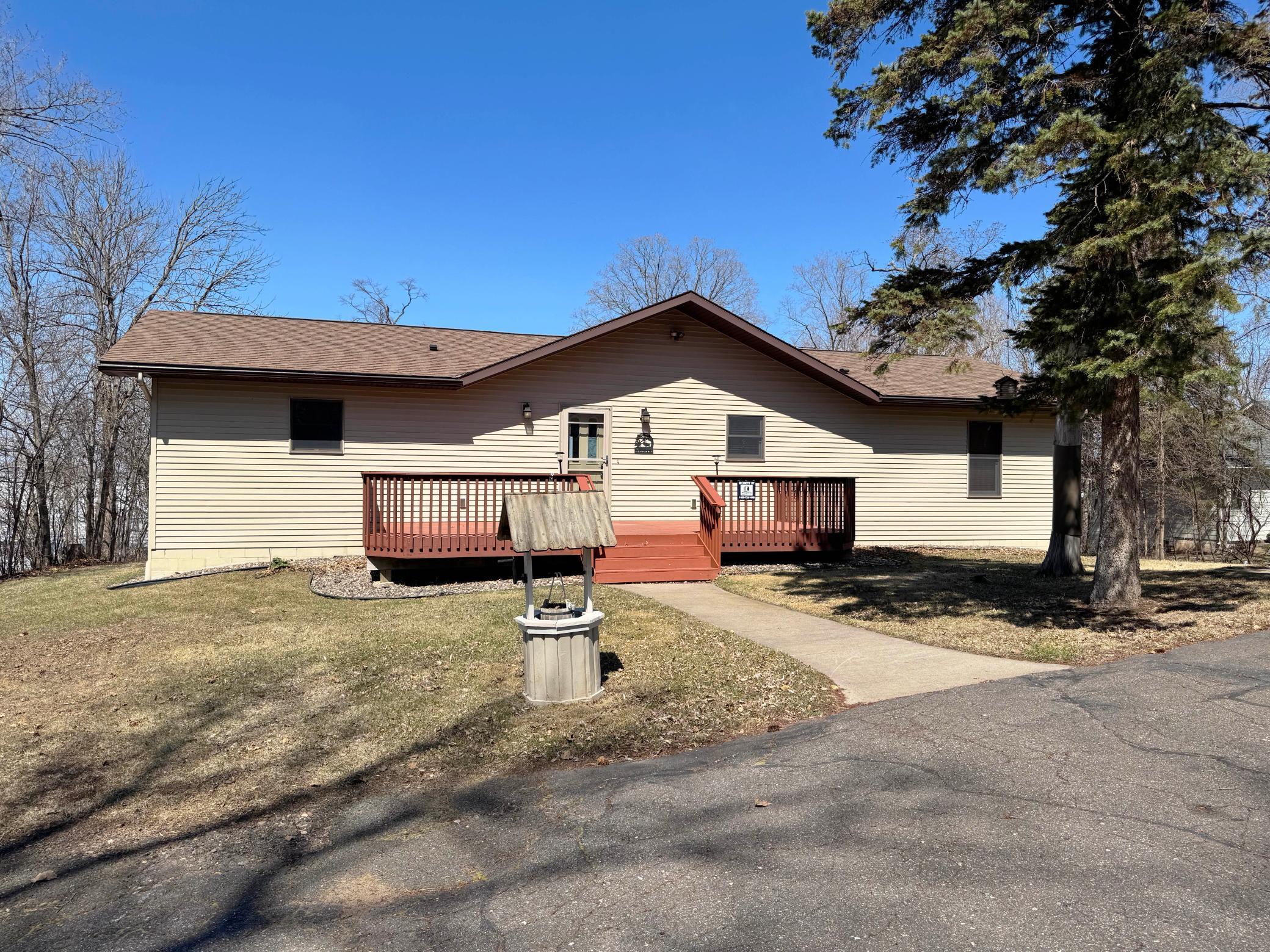 Tucked in on a nice and private lot, here is a shot of the home from the paved driveway. Steel siding and front and back decks for relaxing!