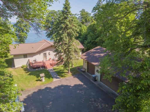 Tucked in on a nice and private lot, here is a shot of the home from just above the paved driveway. Steel siding and front and back decks for relaxing!