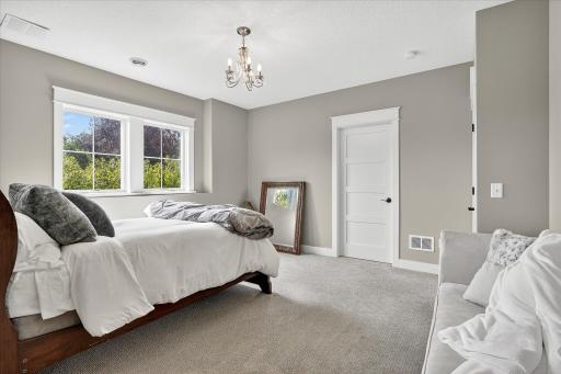 Third bedroom with plush carpeting, large windows, and neutral tones. Also connected to the Jack- and Jill full bathroom.