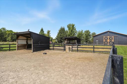 Two covered lean-to's with black fencing, well-suited for your favorite animals both with running water.
