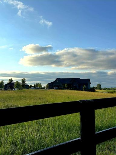 Expansive grounds showcase lush landscaping, wide-open green space, & scenic countryside views. The property includes a barn & fenced pastures, offering versatility for a variety of uses. A perfect blend of natural beauty & functionality.