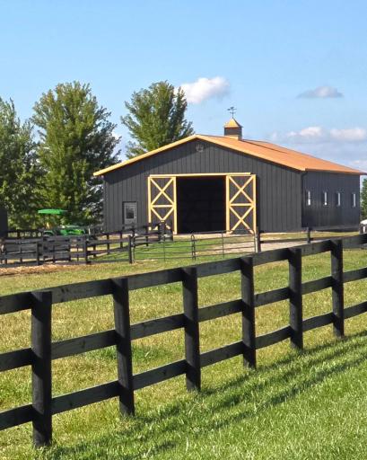 Large outbuilding with barn-style doors, metal roof, and ample space for storage or agricultural use.