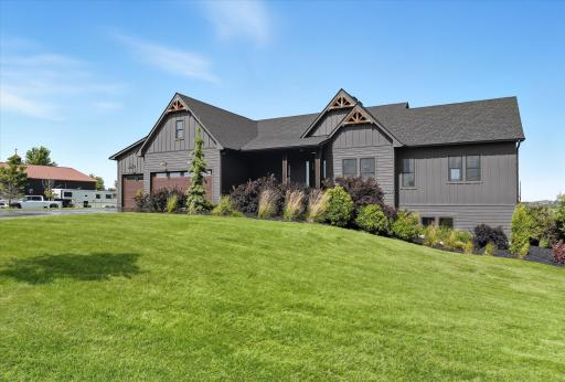 Open, light-filled living spaces with double doors to a maintenance-free deck overlooking peaceful acreage. A great blend of comfort, function, and room to enjoy the outdoors.