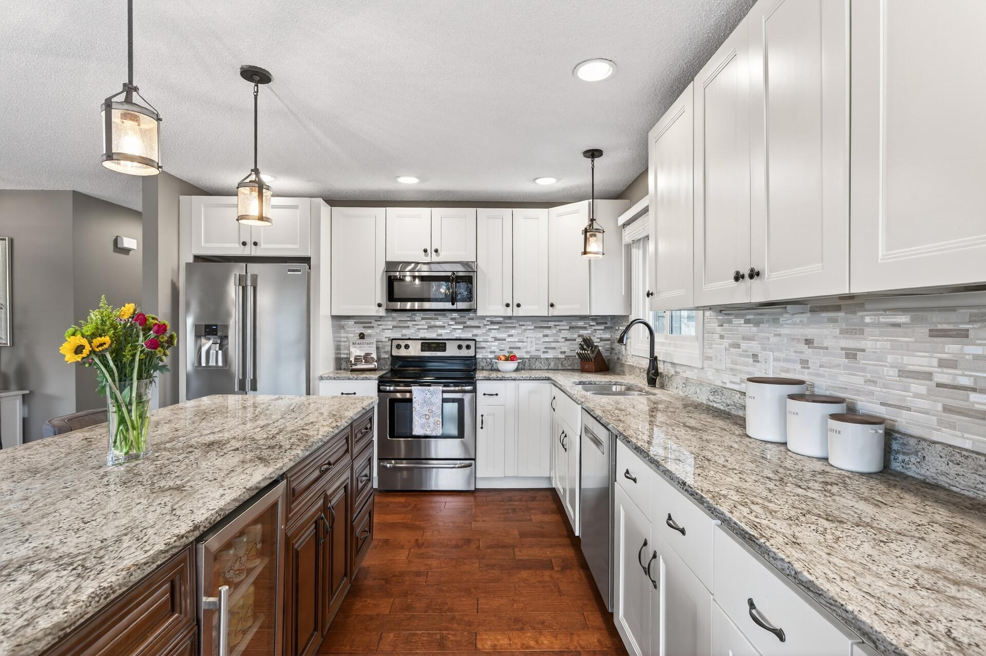 Beautifully updated kitchen with granite countertops and stainless steel appliances.