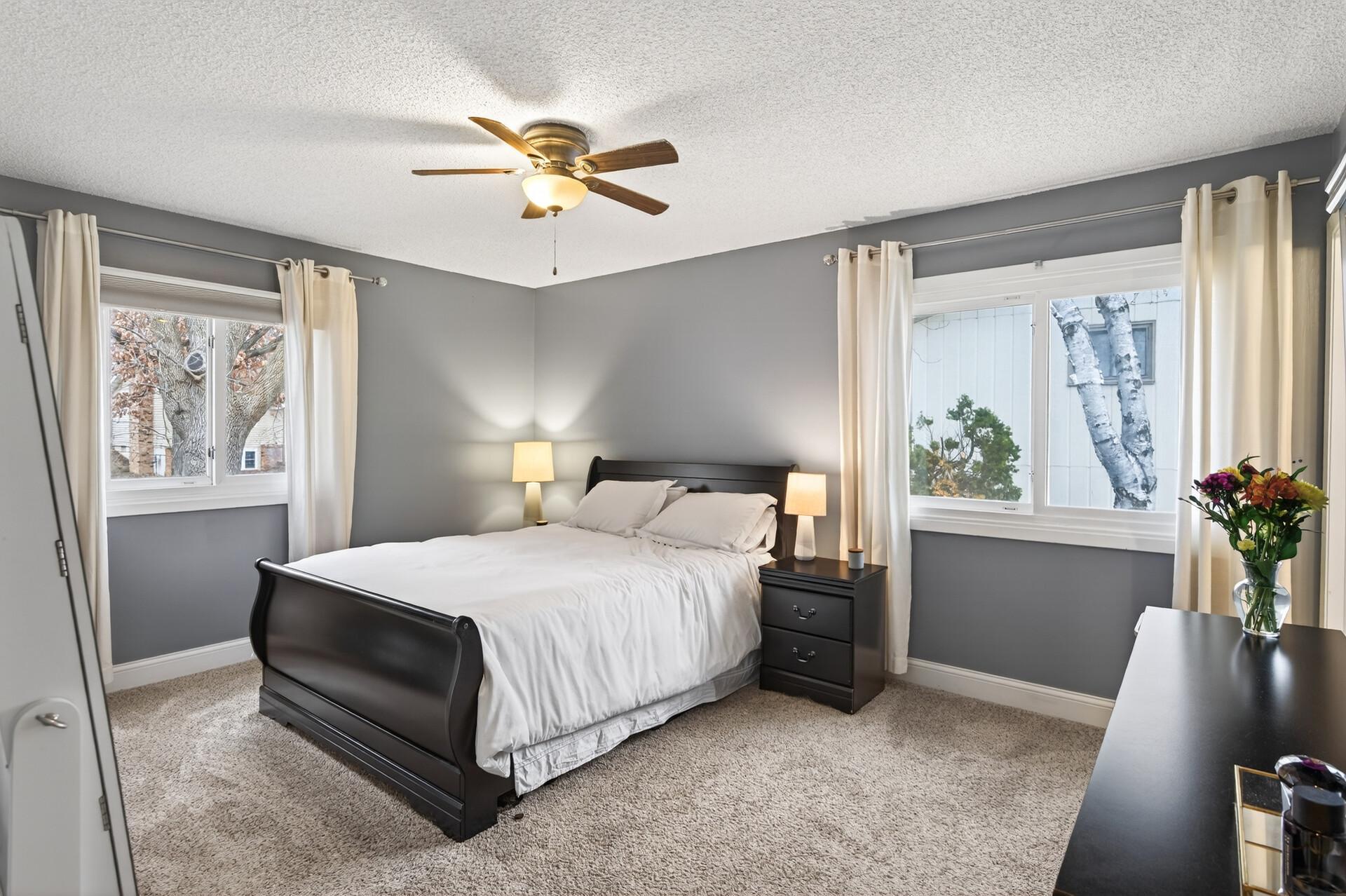 Comfortable primary suite bedroom with great natural light.
