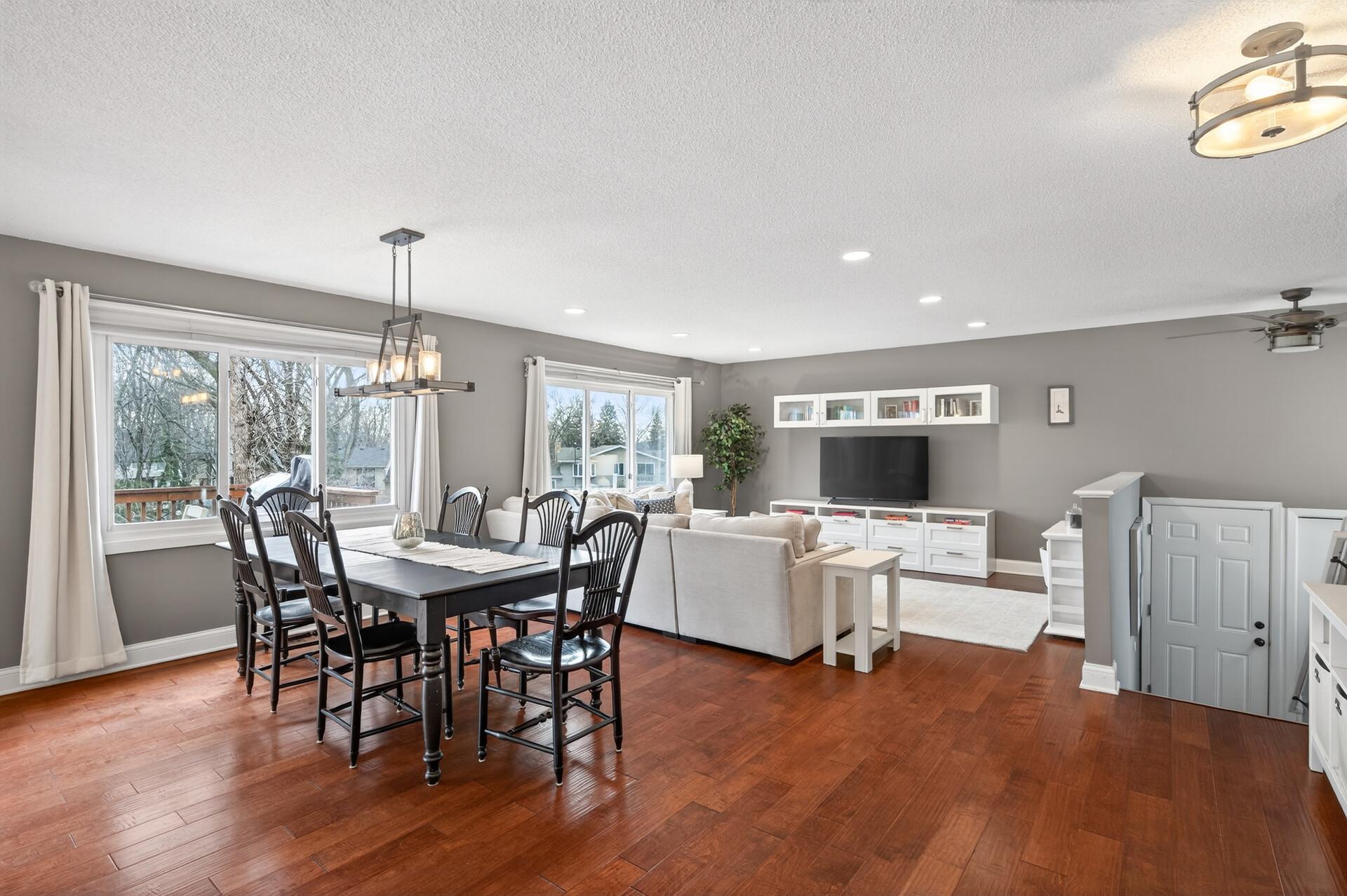 Spacious living room filled with natural light and beautiful flooring.