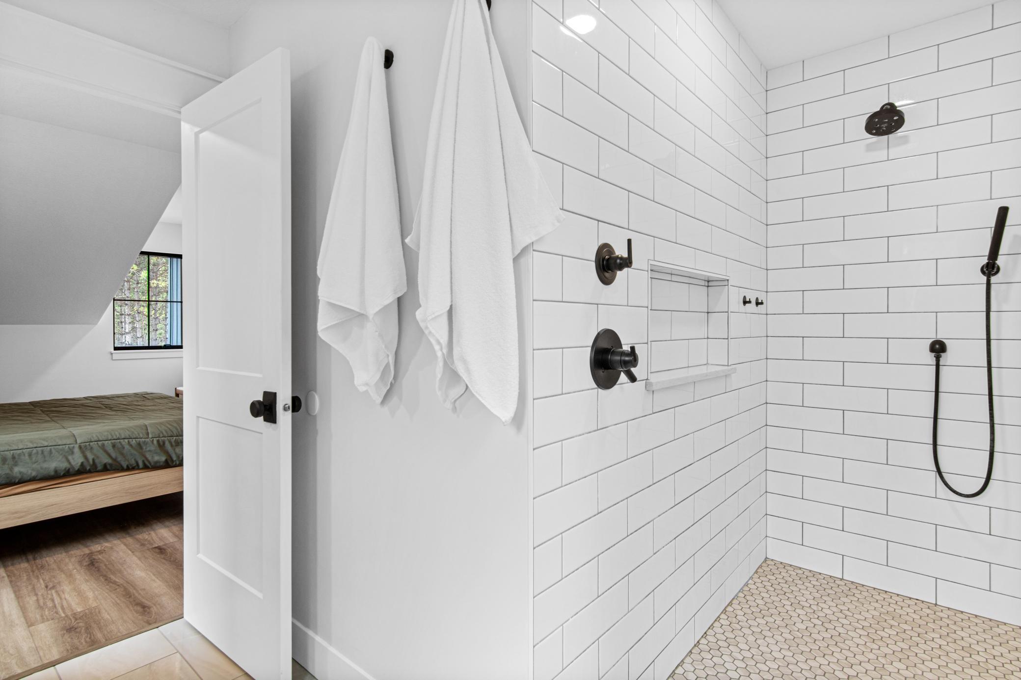 En-suite primary bathroom with expansive walk-in tile shower