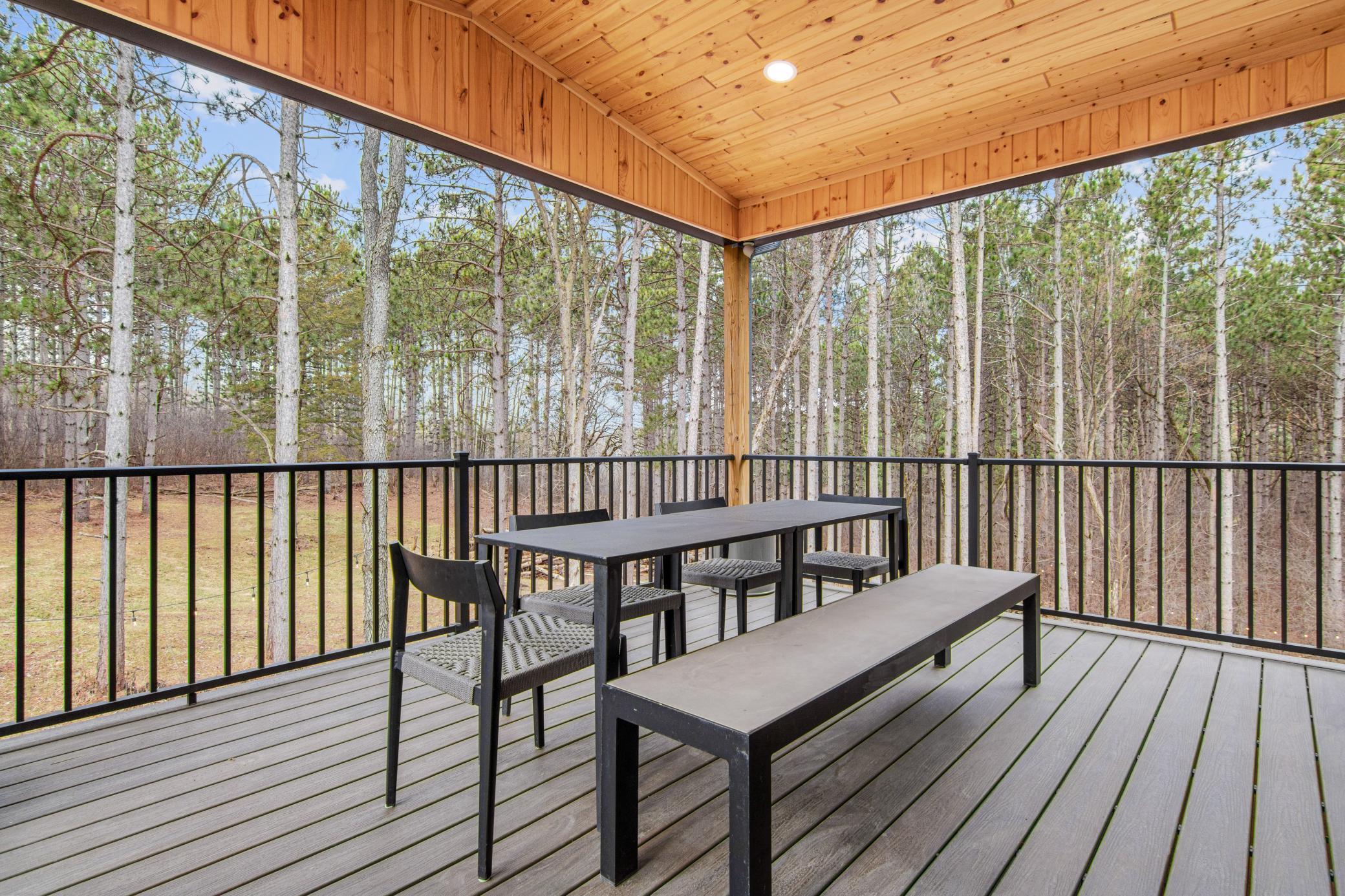 Covered deck with cedar ceiling and ceiling fan, ideal for relaxing or entertaining
