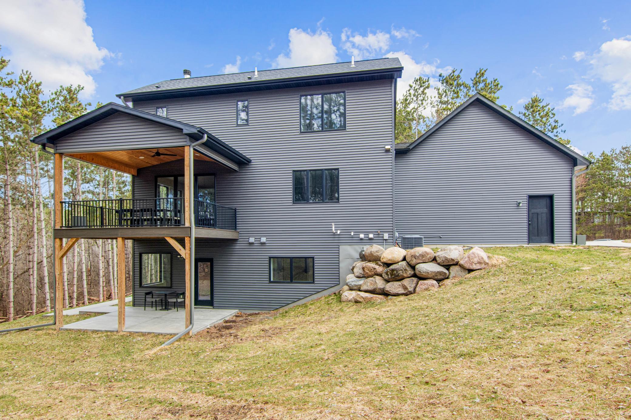Elevated deck and covered patio set amongst mature trees