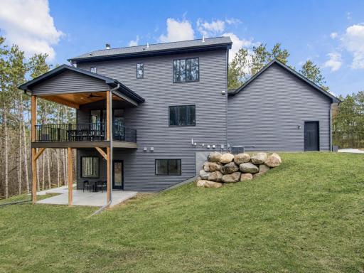 Elevated deck and covered patio set amongst mature trees