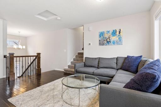 Two story foyer with open staircase featuring iron balusters and wood treads.