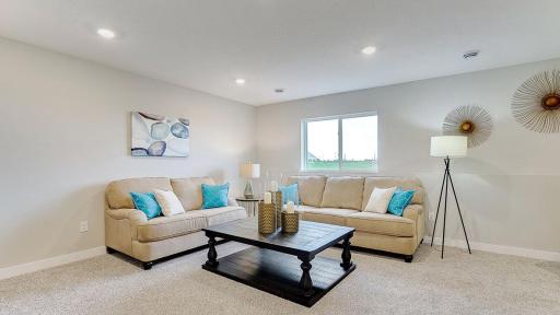 This is a finished basement in a model home; shown in order to give buyer an idea of what the basement space could look like once finished. The basement shown in these photos is of a lookout basement. Home listed is a walkout and is unfinished.