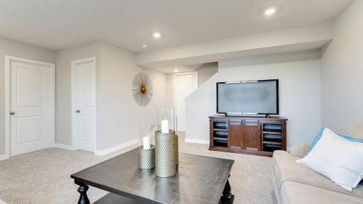 This is a finished basement in a model home; shown in order to give buyer an idea of what the basement space could look like once finished. The basement shown in these photos is of a lookout basement. Home listed is a walkout and is unfinished.