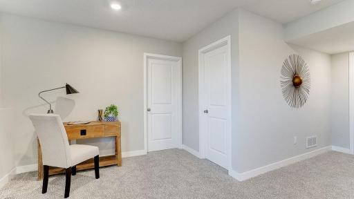 This is a finished basement in a model home; shown in order to give buyer an idea of what the basement space could look like once finished. The basement shown in these photos is of a lookout basement. Home listed is a walkout and is unfinished.