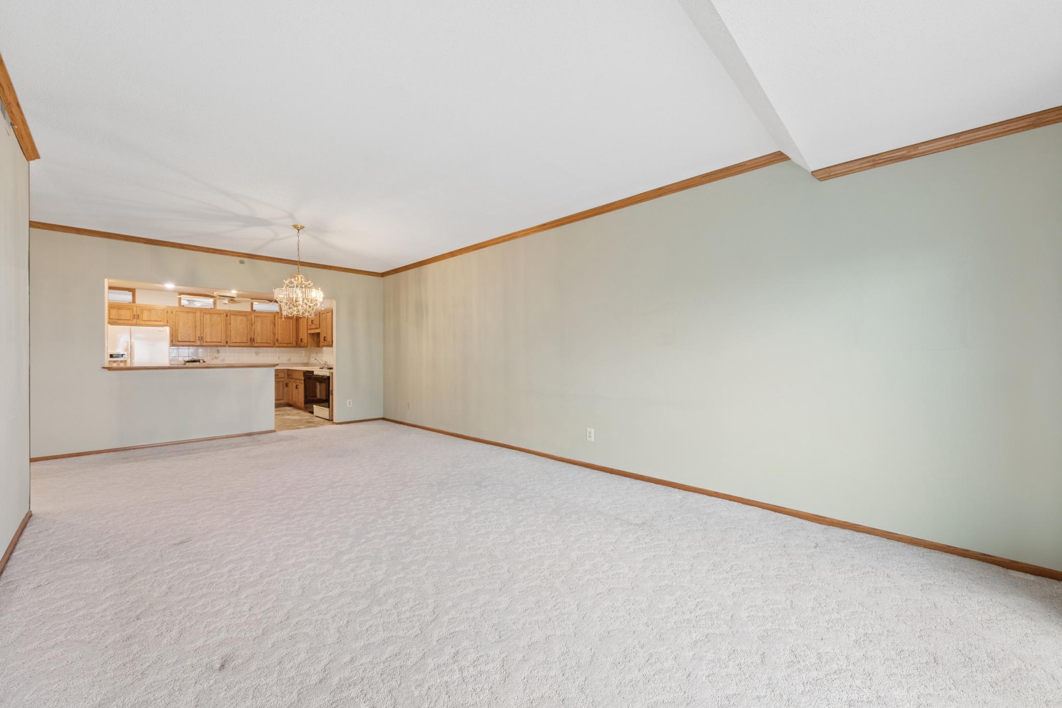 A sprawling living area ready for your personal touch, featuring solid concrete construction for premium sound insulation.