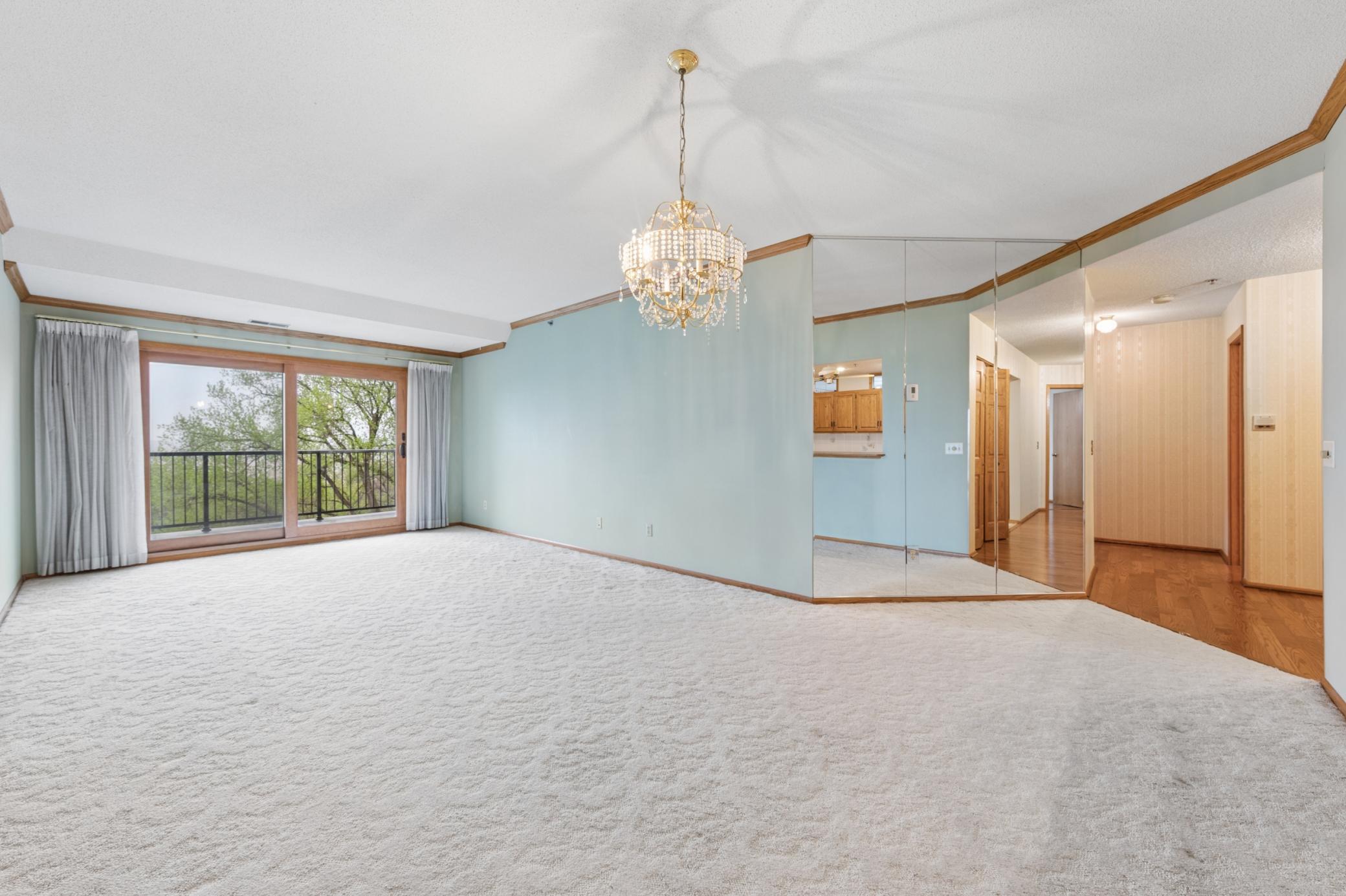Wall-to-wall sliding glass invites the tranquil outdoors into a remarkably quiet, solidly constructed living room.