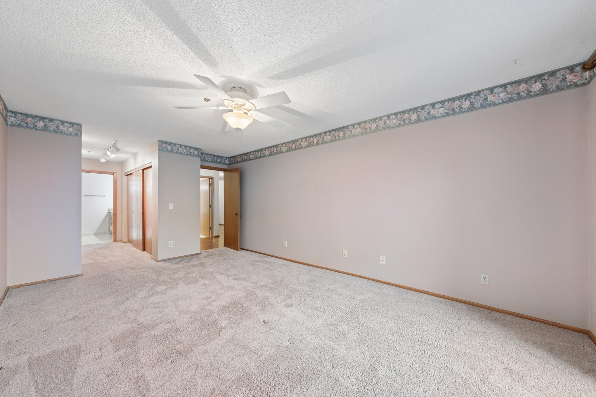 A comfortable, private sanctuary featuring an en-suite layout and ample closet storage.